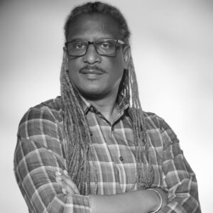 A person with long hair wearing glasses